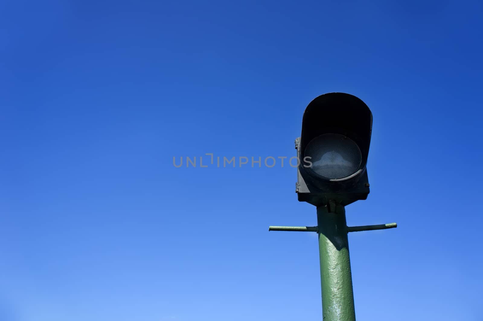 green lamppost on background of blue sky by wolegsan