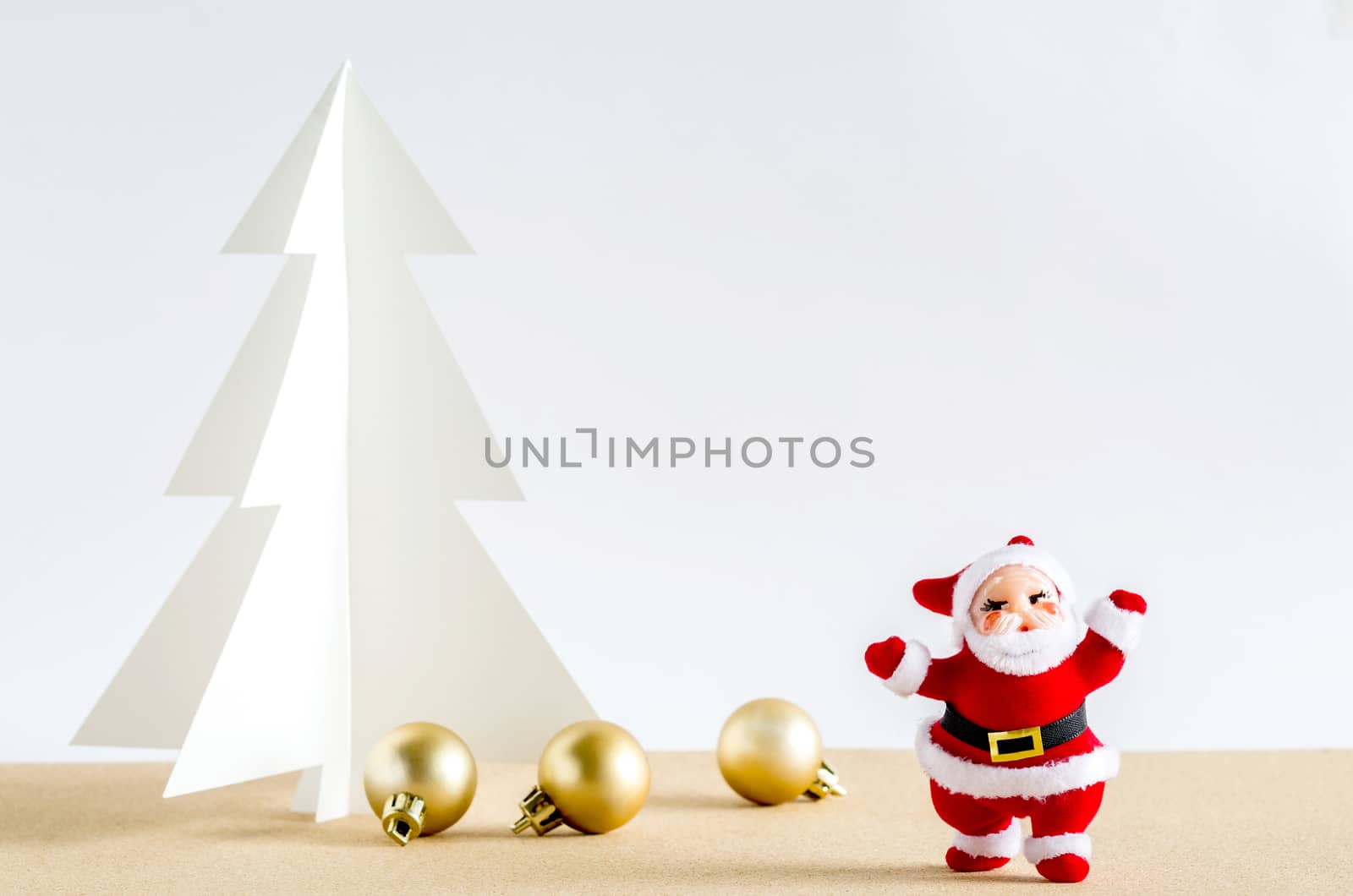 Christmas background. Santa Claus, golden balls and christmas tree paper craft.