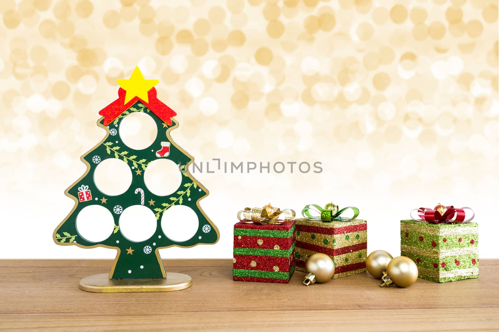 Christmas background. Christmas tree, golden balls and gift boxes with lights snow winter background. 