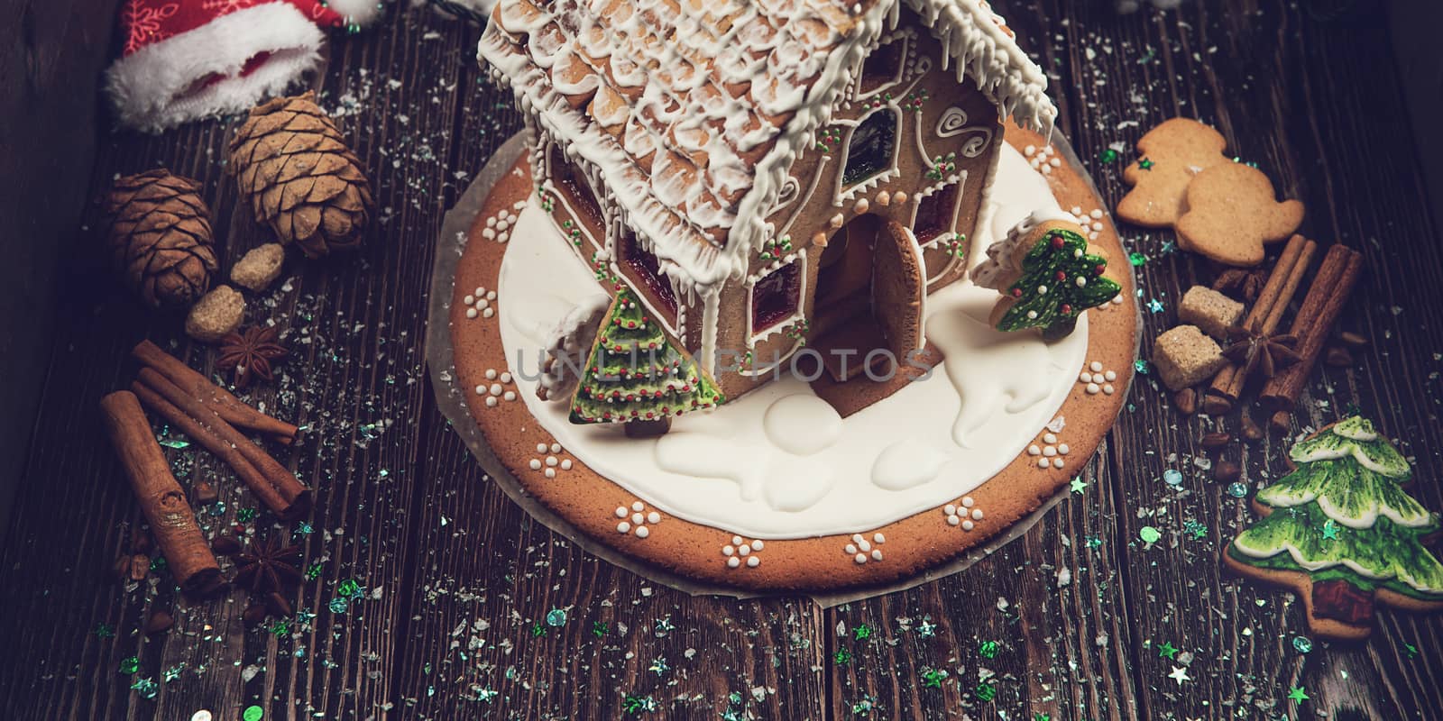 Homemade gingerbread house on dark background, xmas theme