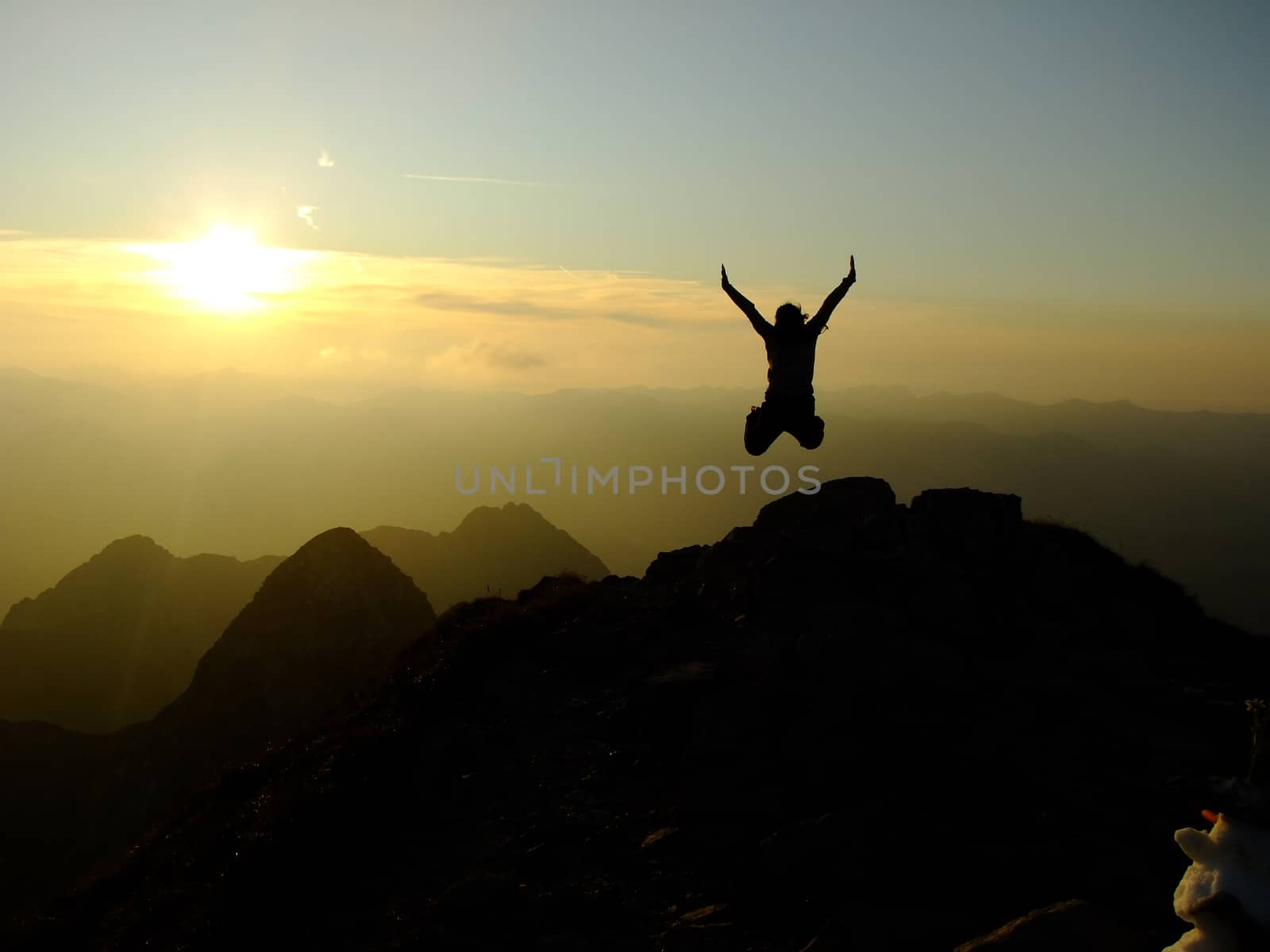 Woman jumping Hands up on the Top of the Nebelhorn Mountains in Germany Alps