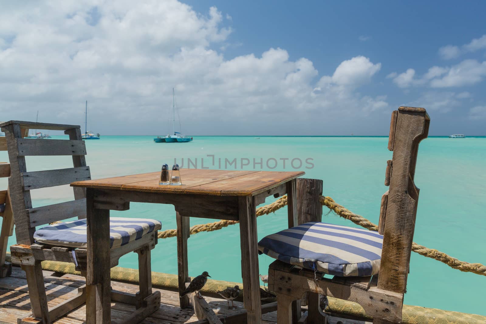 Table with a Sea View in Aruba by chrisukphoto