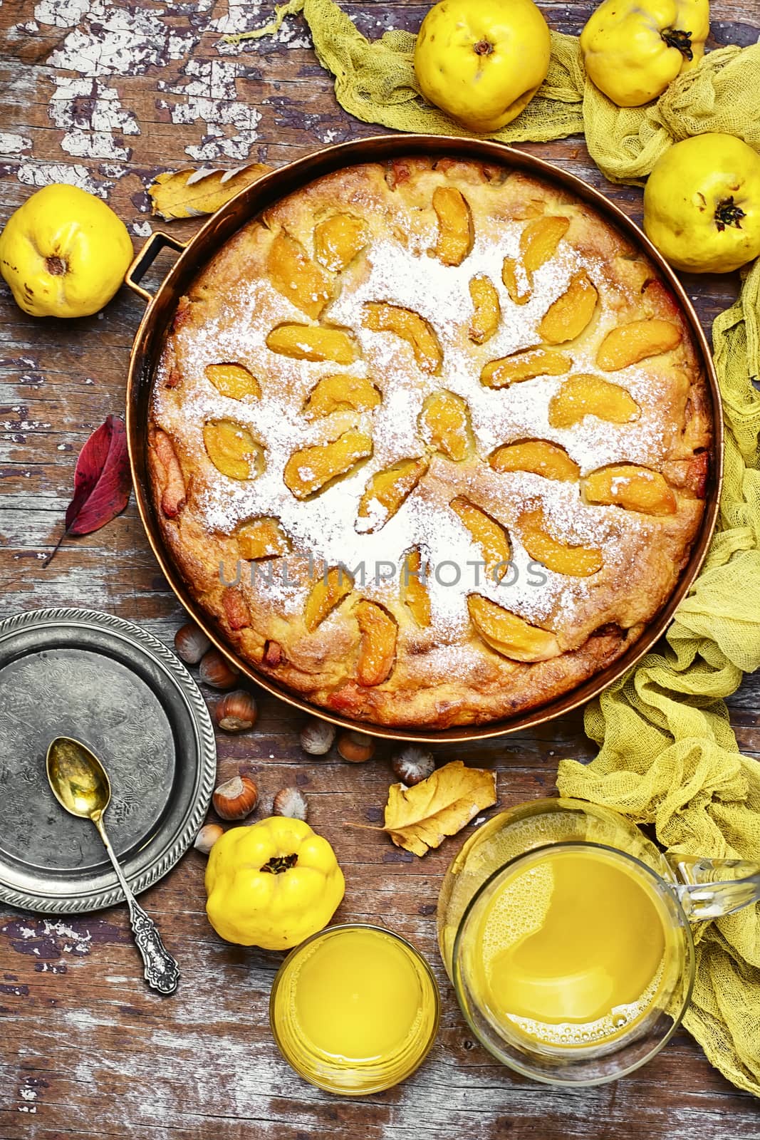 Autumn pie with ripe fruits of quince in a rustic style