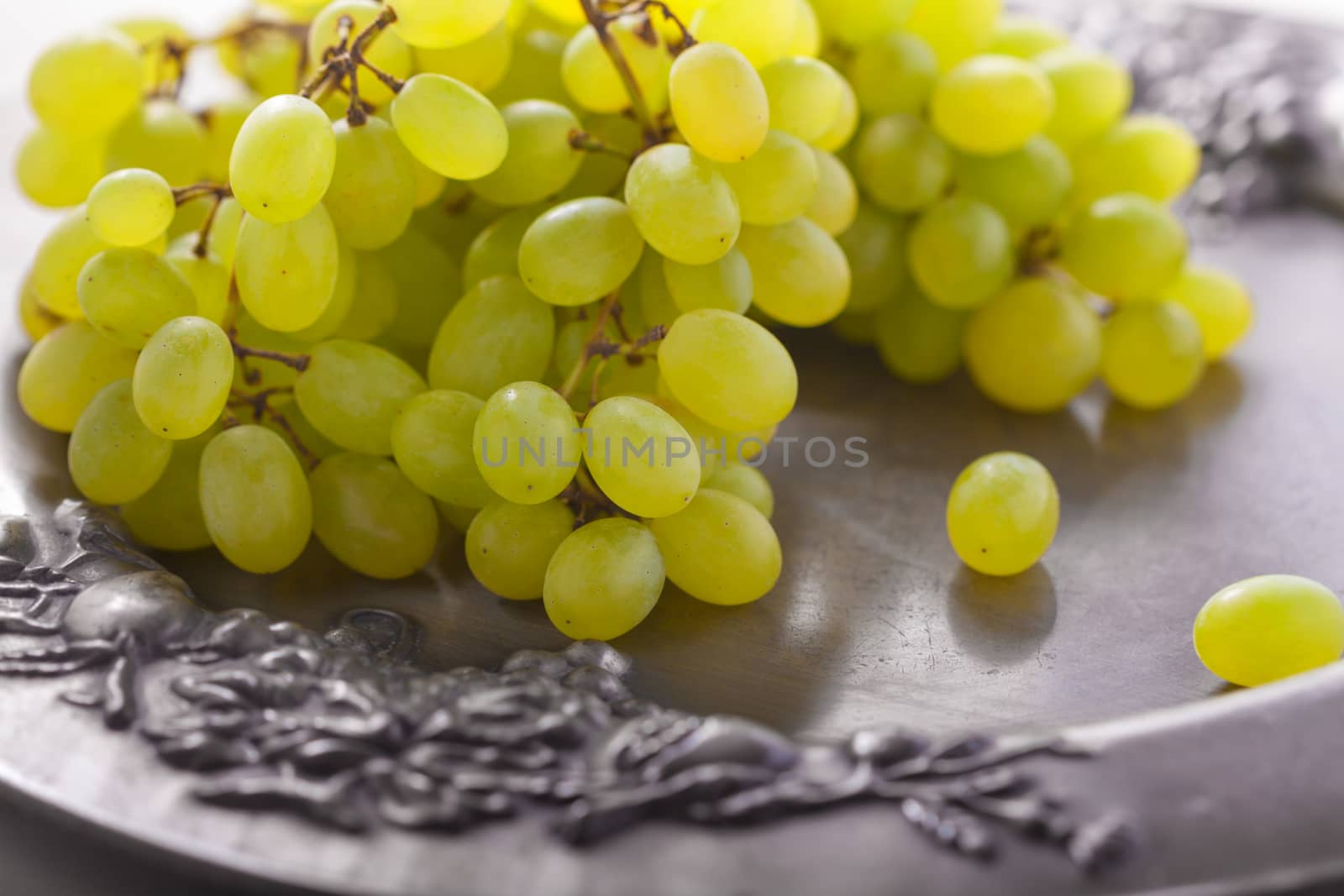 Bunch of white grapes on a tray.