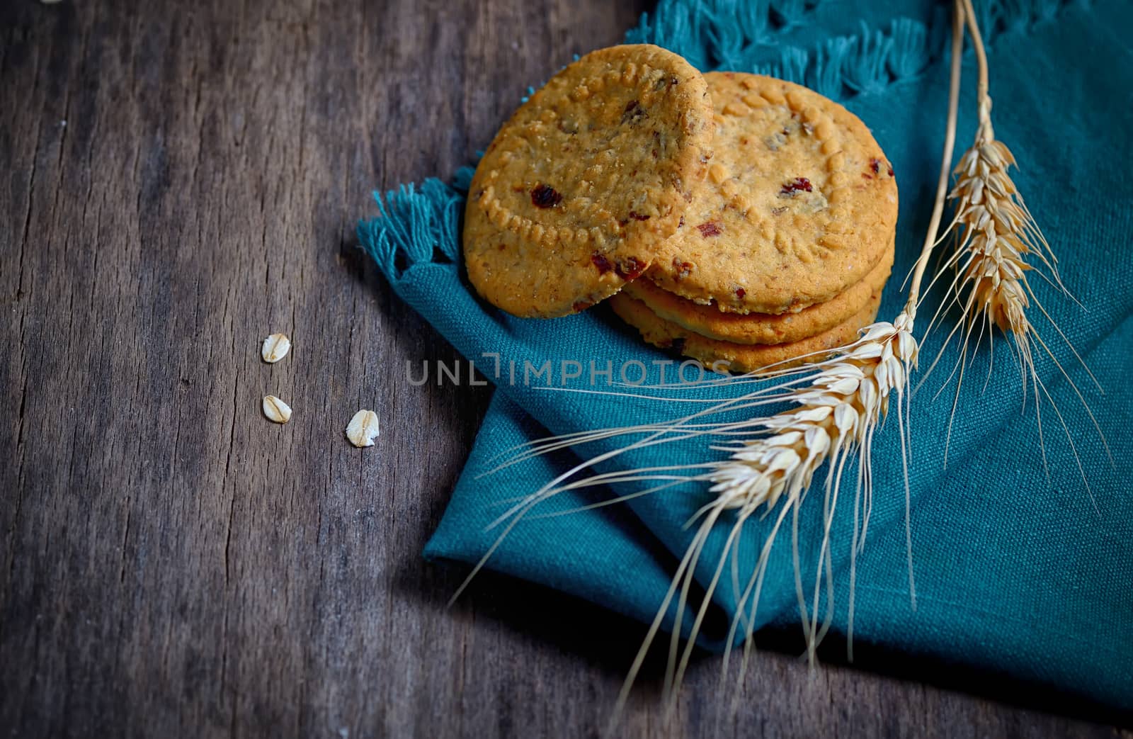 oatmeal cookies and ears on wooden background