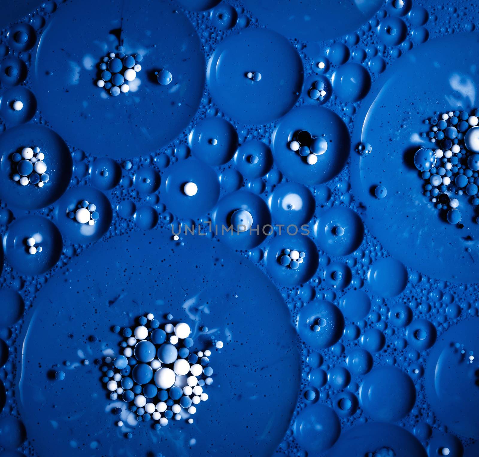 abstract background colored milk balls in oil