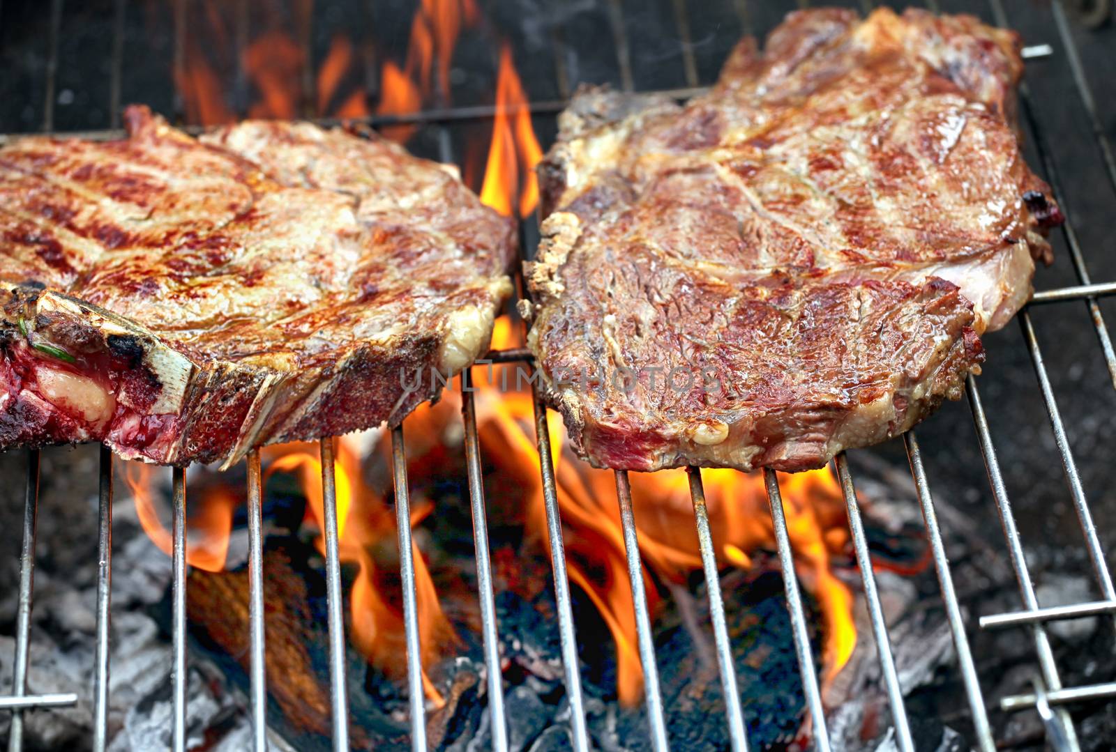 Beef steaks on the grill by mmproduct