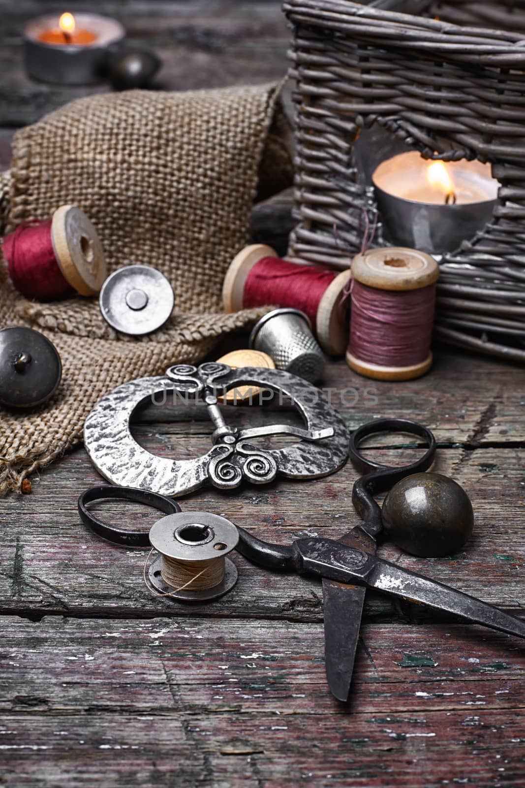 Spools of sewing threads and buttons from clothing