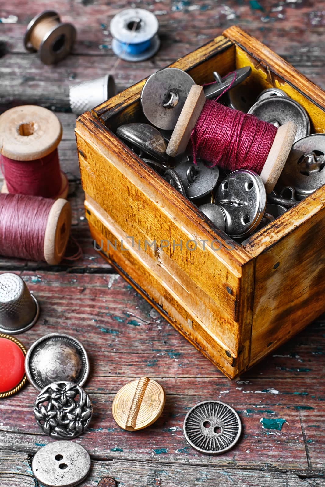 Retro wooden box with buttons and thread