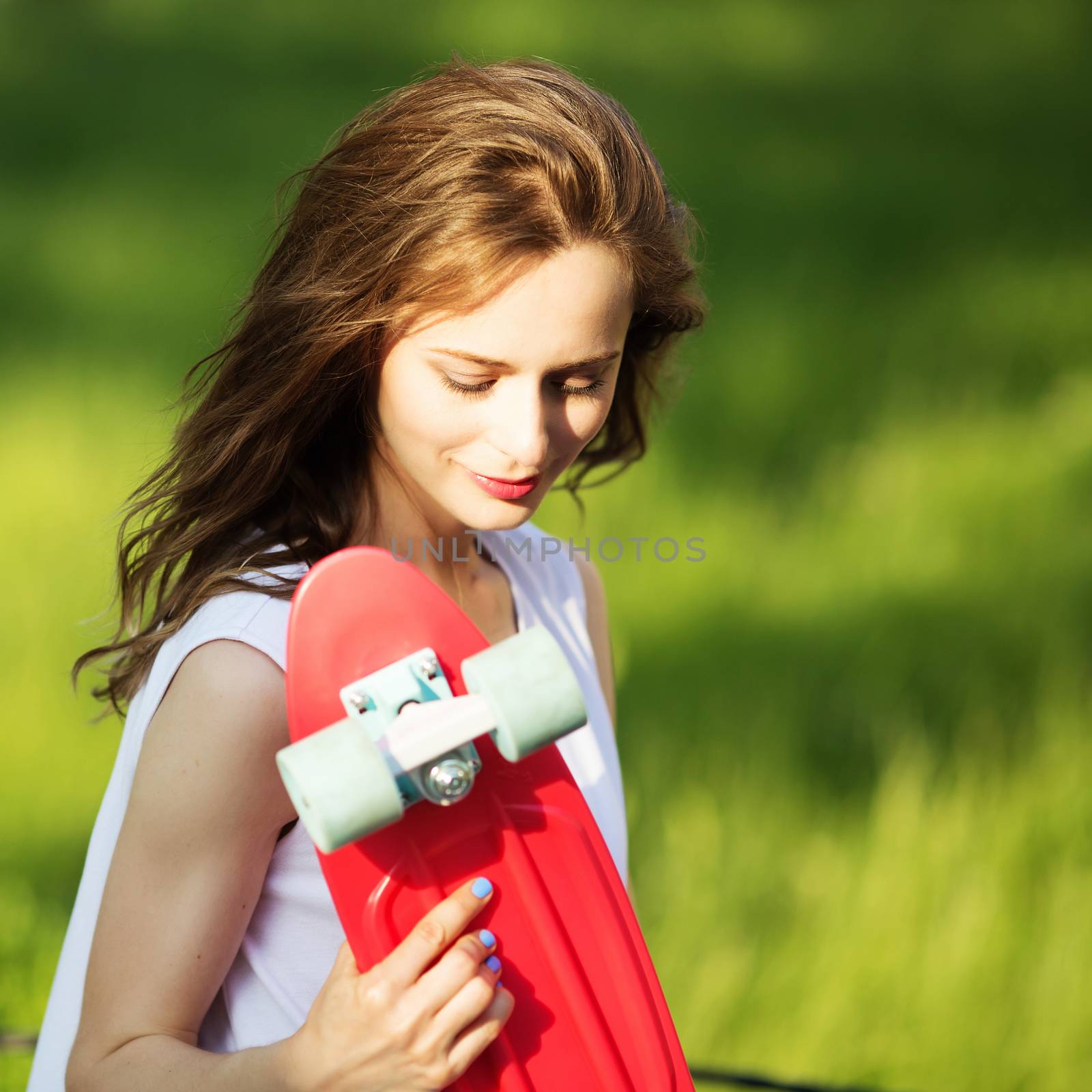 Girl holding a plastic skate board outdoors by natazhekova