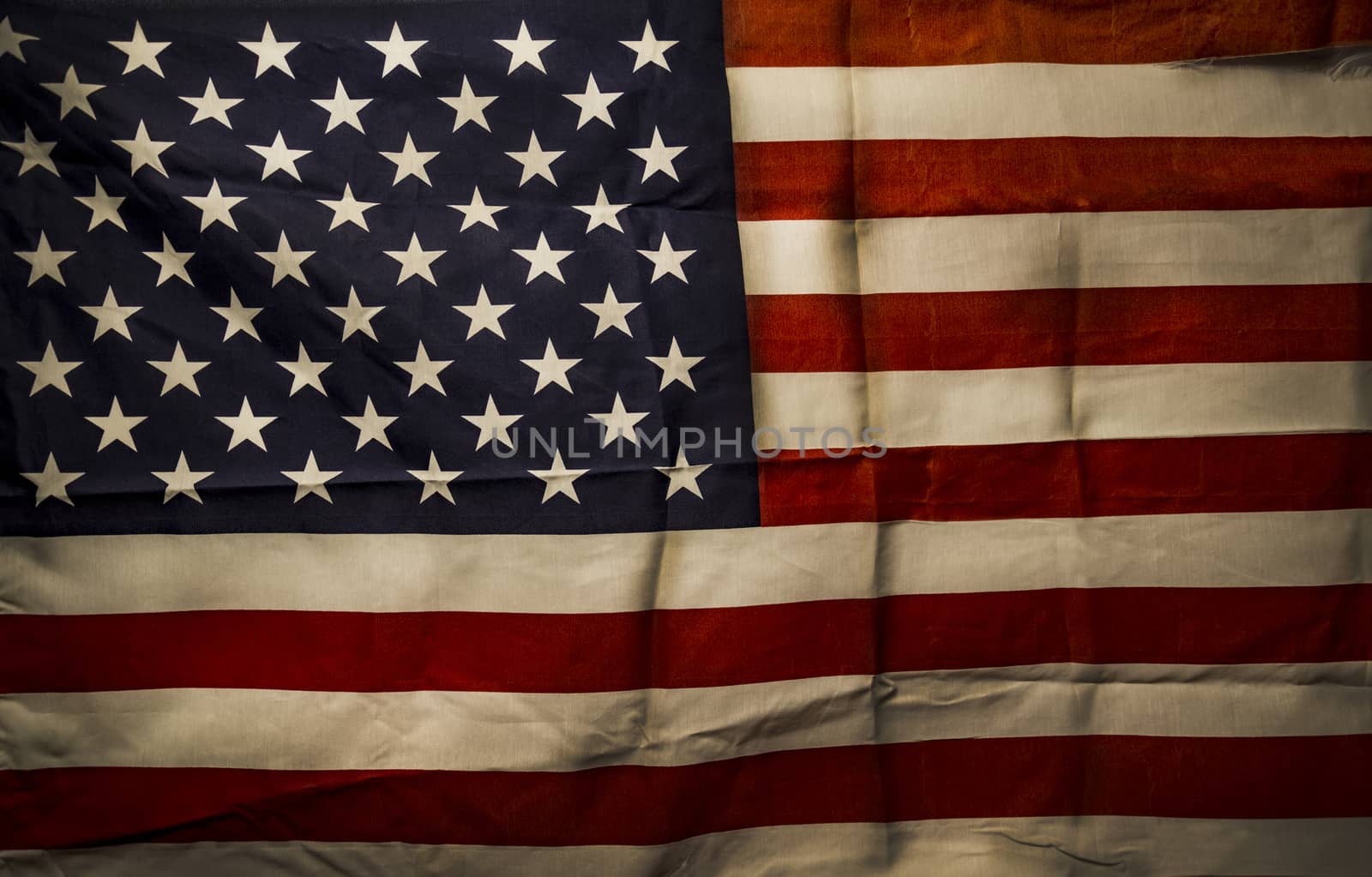 Closeup of creased grunge American flag, stars and stripes
