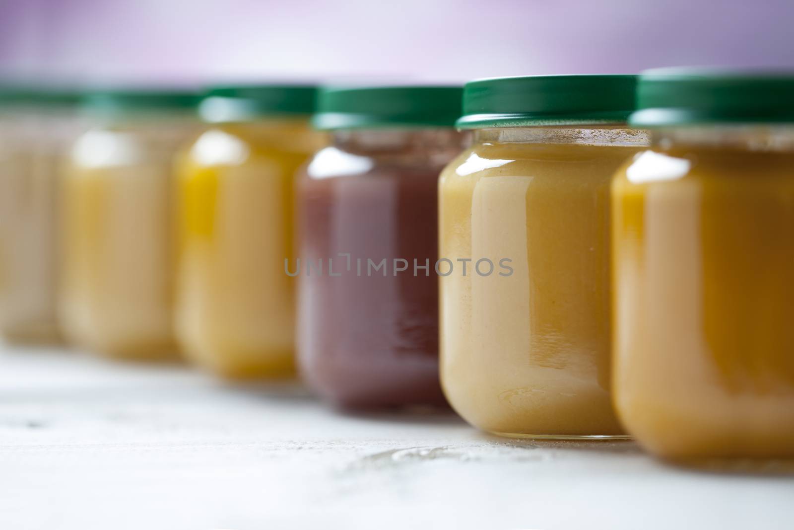 healthy ready-made baby food on a wooden table.