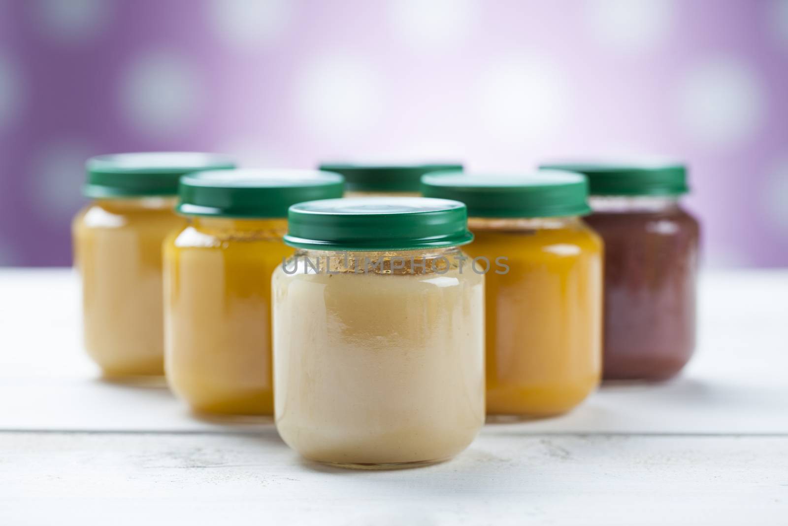 healthy ready-made baby food on a wooden table.