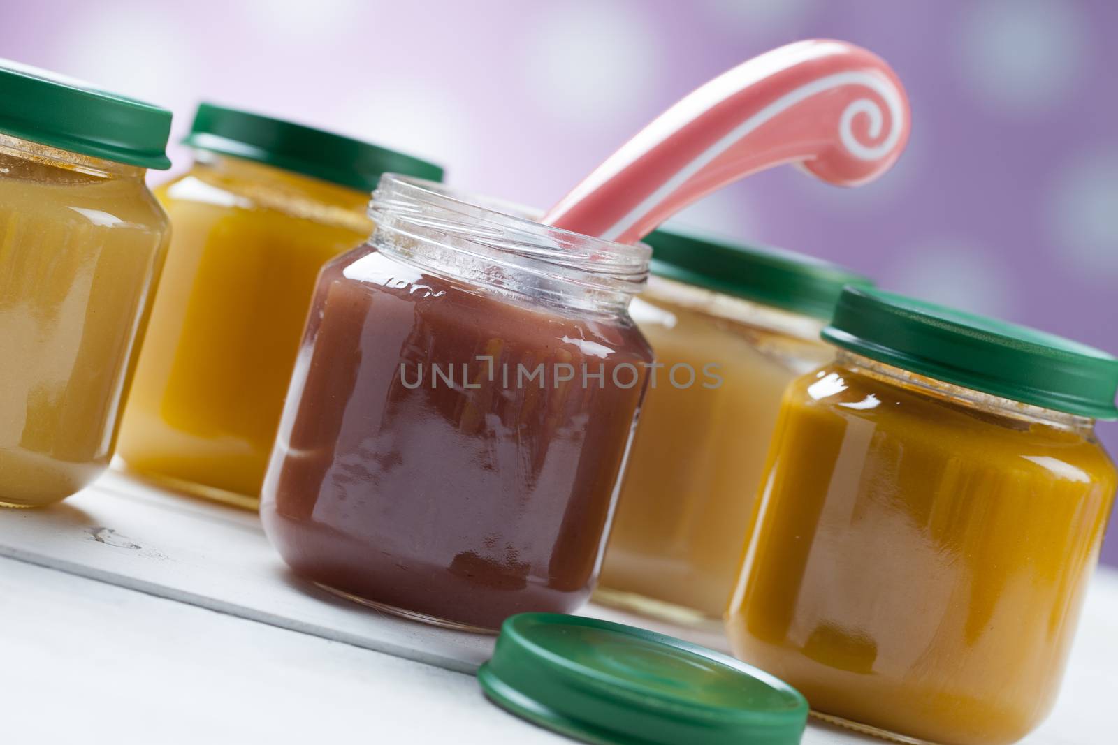 healthy ready-made baby food on a wooden table.