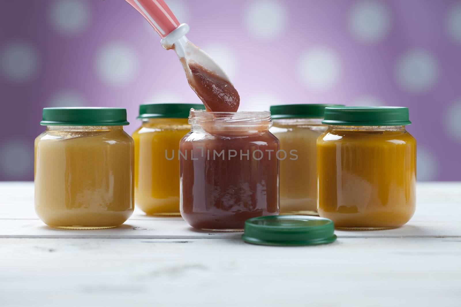 healthy ready-made baby food on a wooden table.