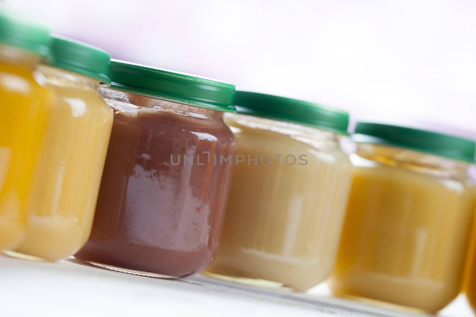 healthy ready-made baby food on a wooden table.