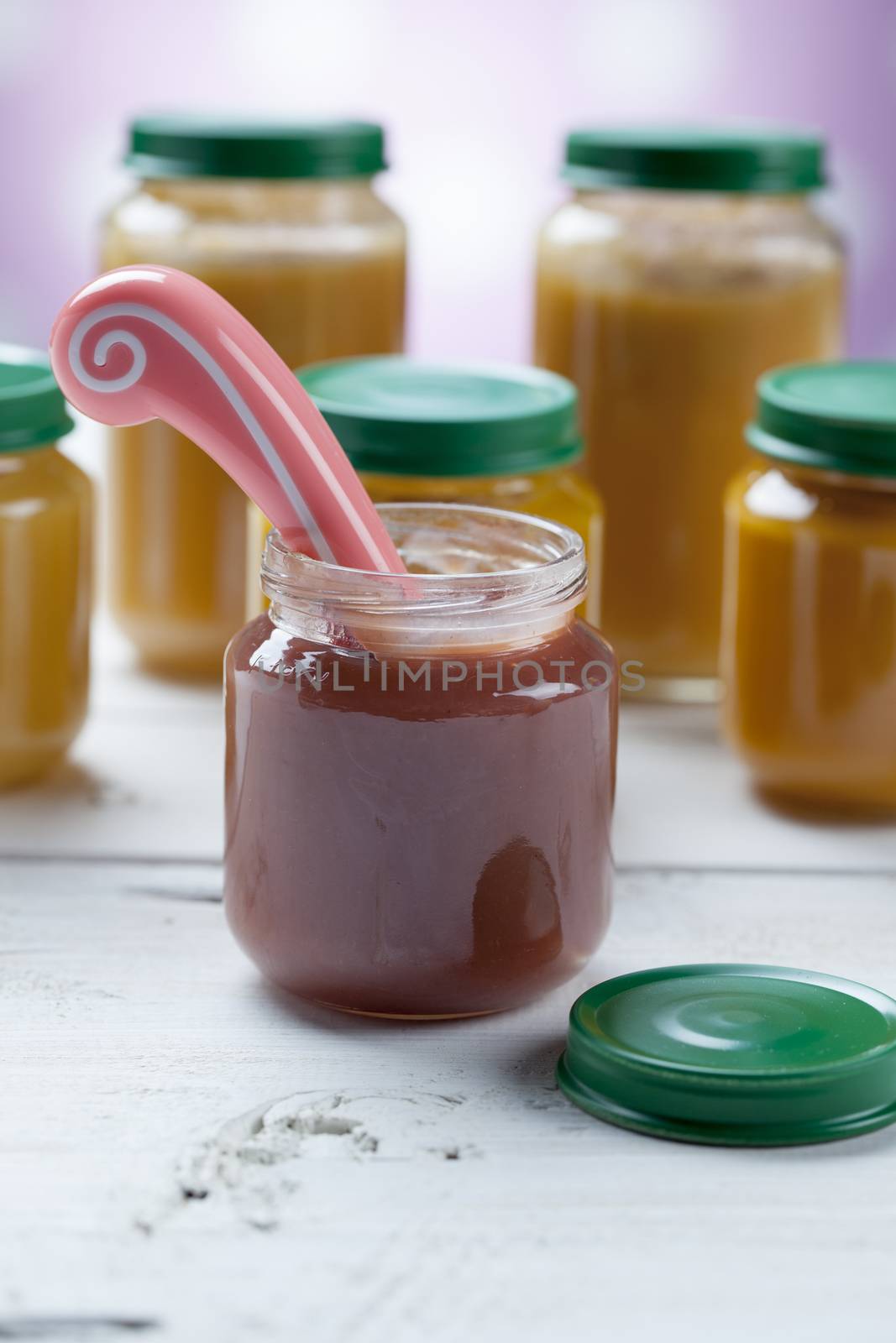 healthy ready-made baby food on a wooden table.