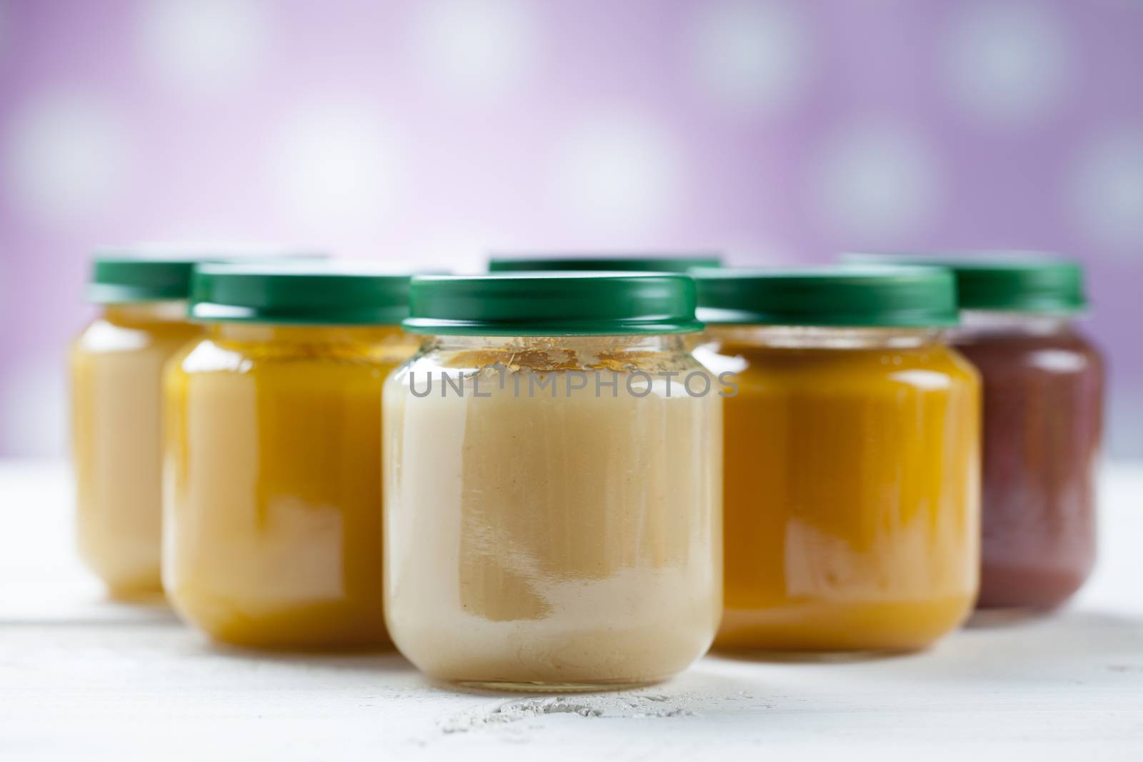 healthy ready-made baby food on a wooden table.