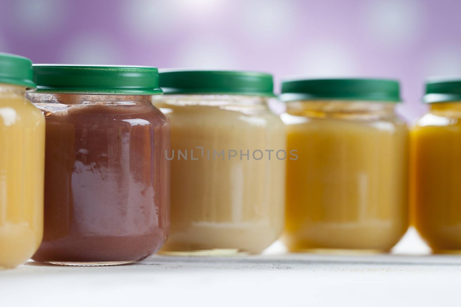 healthy ready-made baby food on a wooden table.