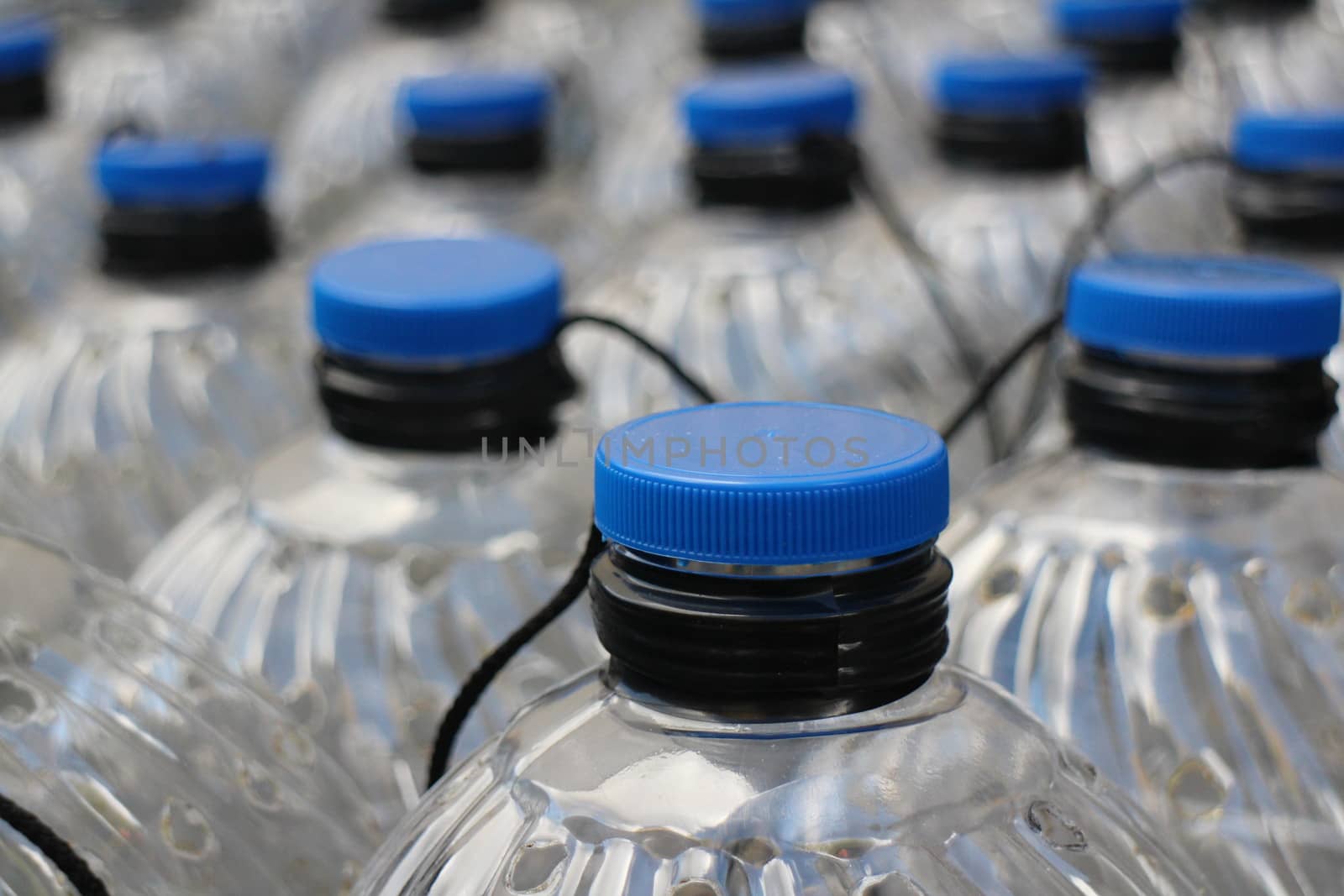 Rows translucent plastic bottles close to