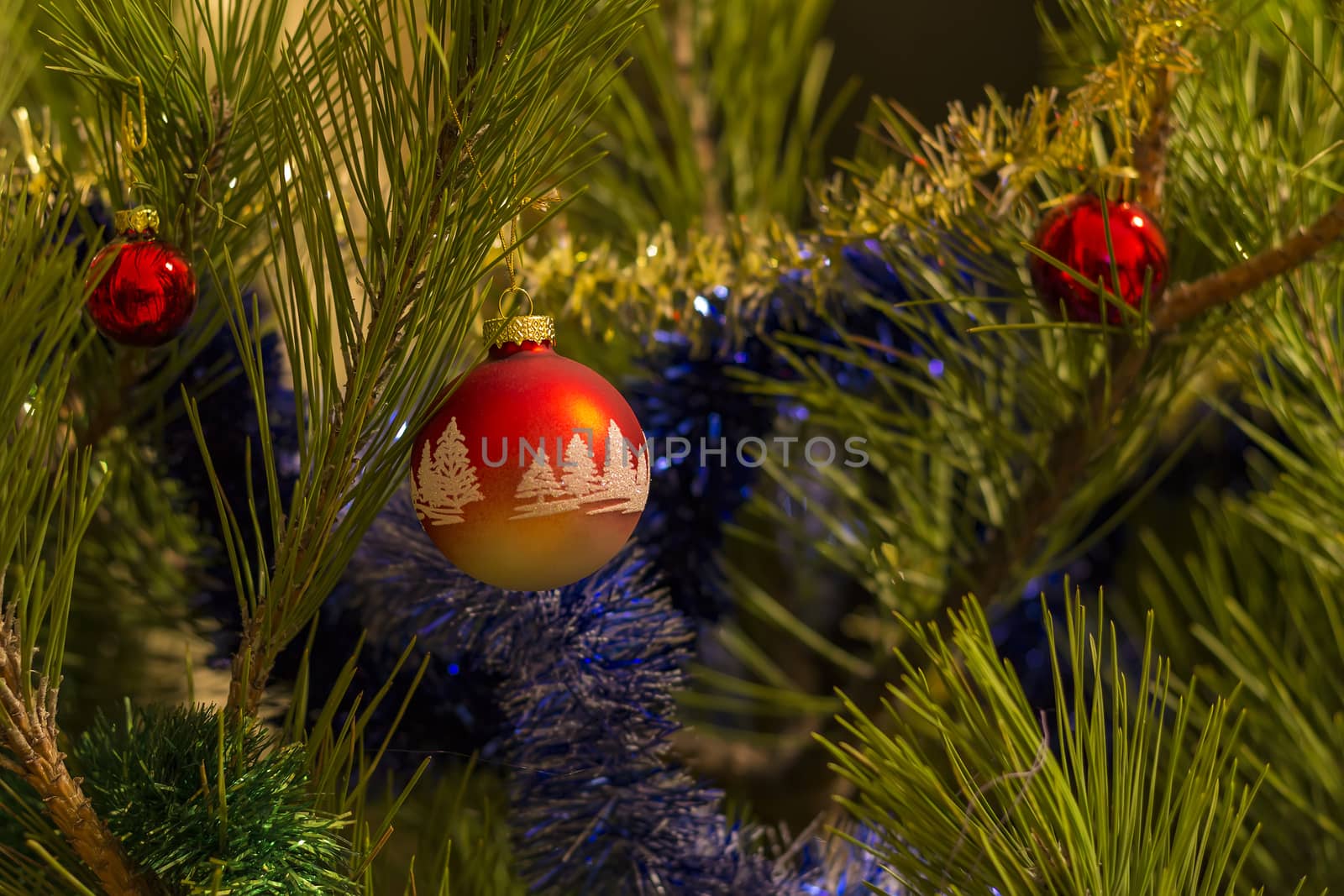 beautiful red christmas balls and garland on christmas tree