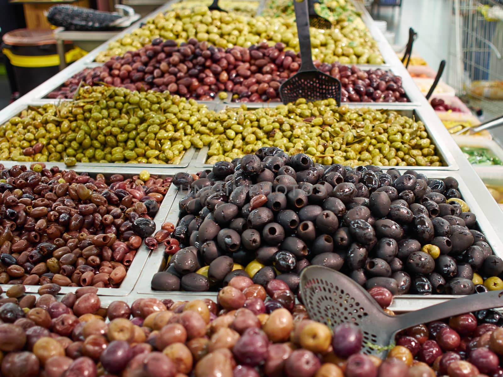 Selection of Mediterranean style pickled green and black olives for sale 