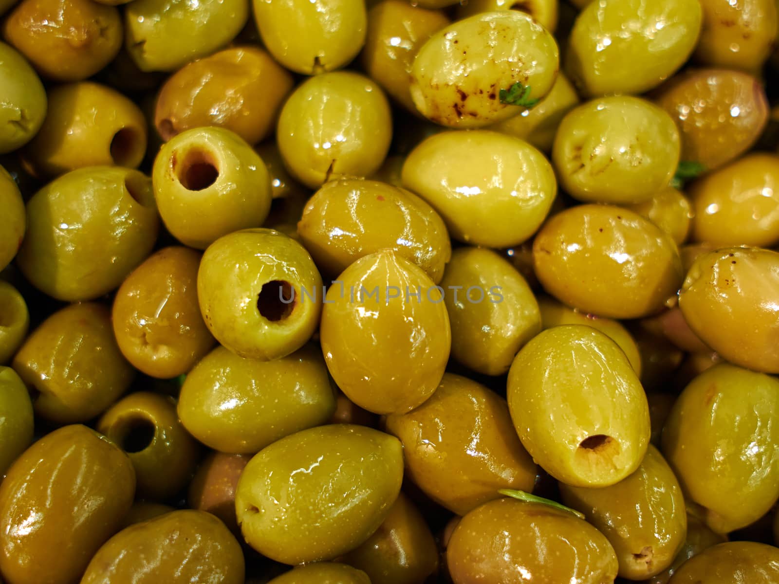 Traditional pickled Mediterranean style green olives for sale in a market shop