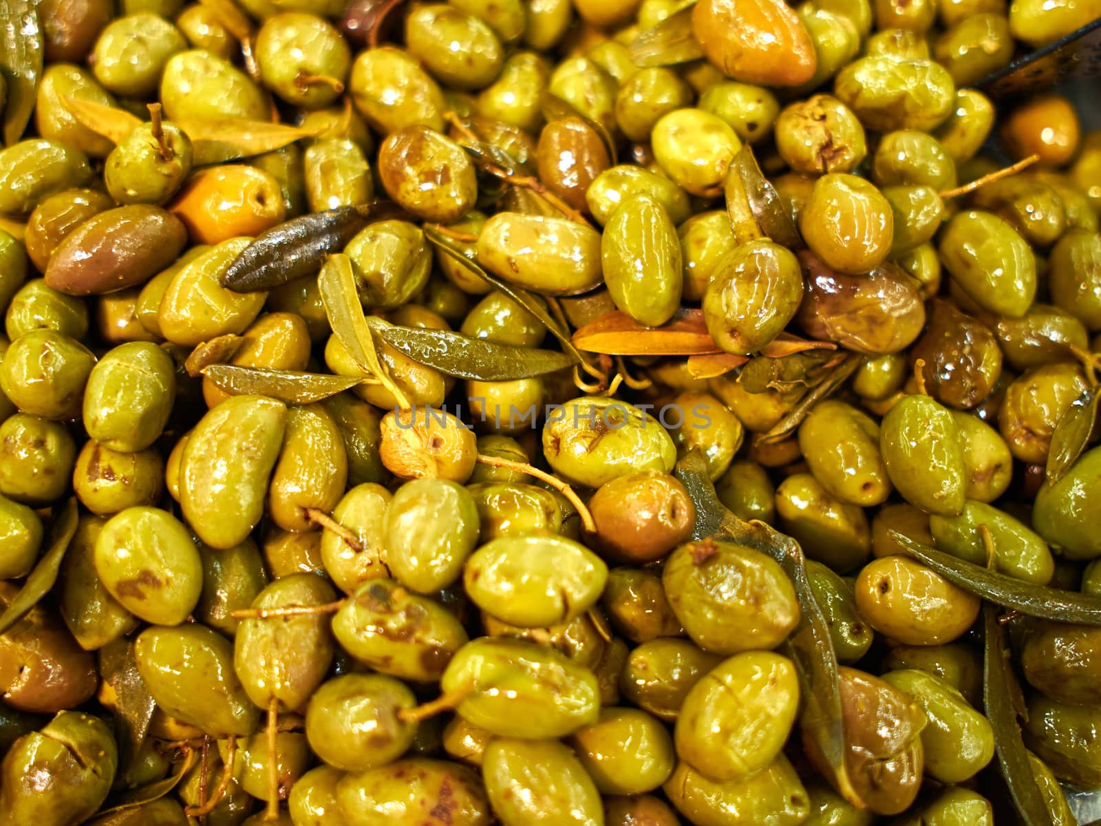 Tradtional pickled Mediterranean style green olives for sale in a market shop