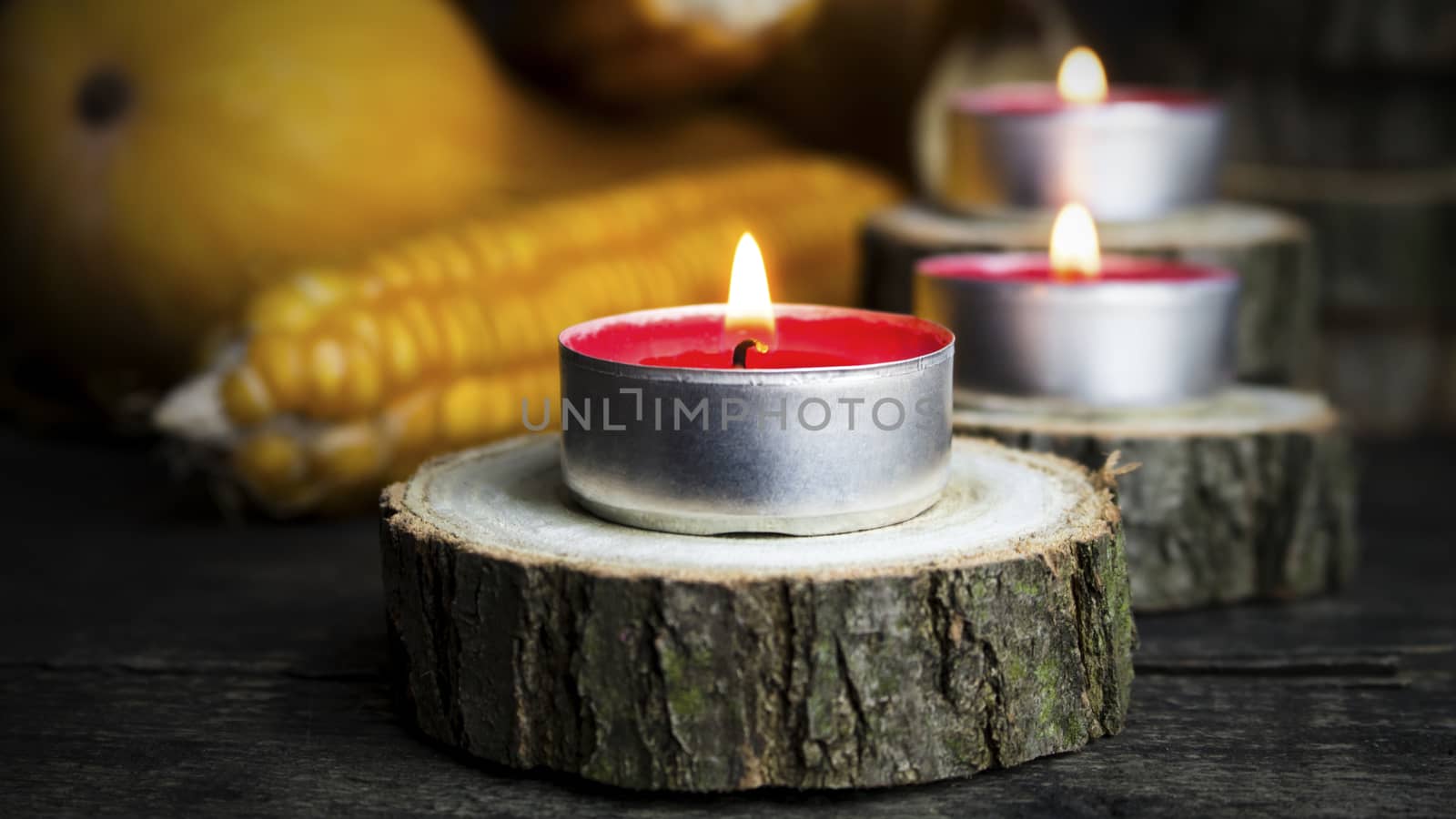 Burning Candles With Pumpkins, Corncob, autumn leaves in the bac by alexandarilich