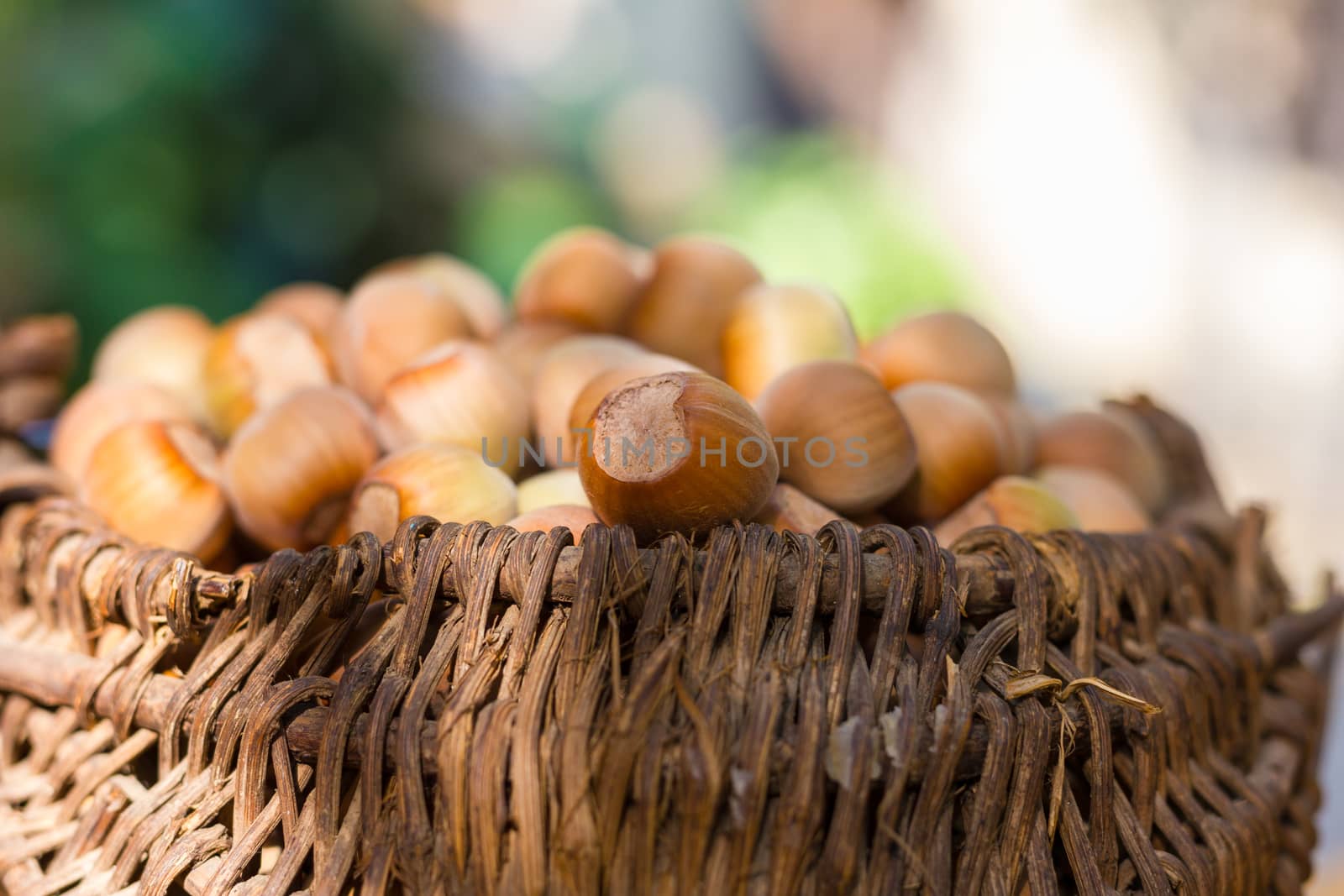 A basket of toasted hazelnuts inviting by maggee