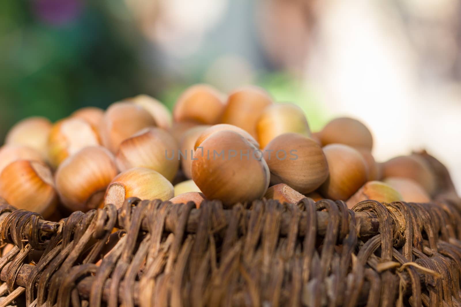 A basket of toasted hazelnuts inviting by maggee