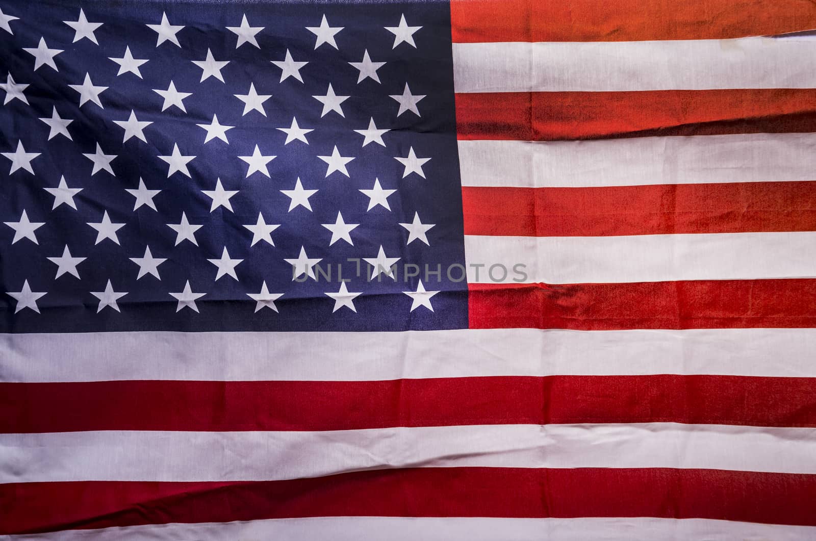 Closeup of creased grunge American flag, stars and stripes
