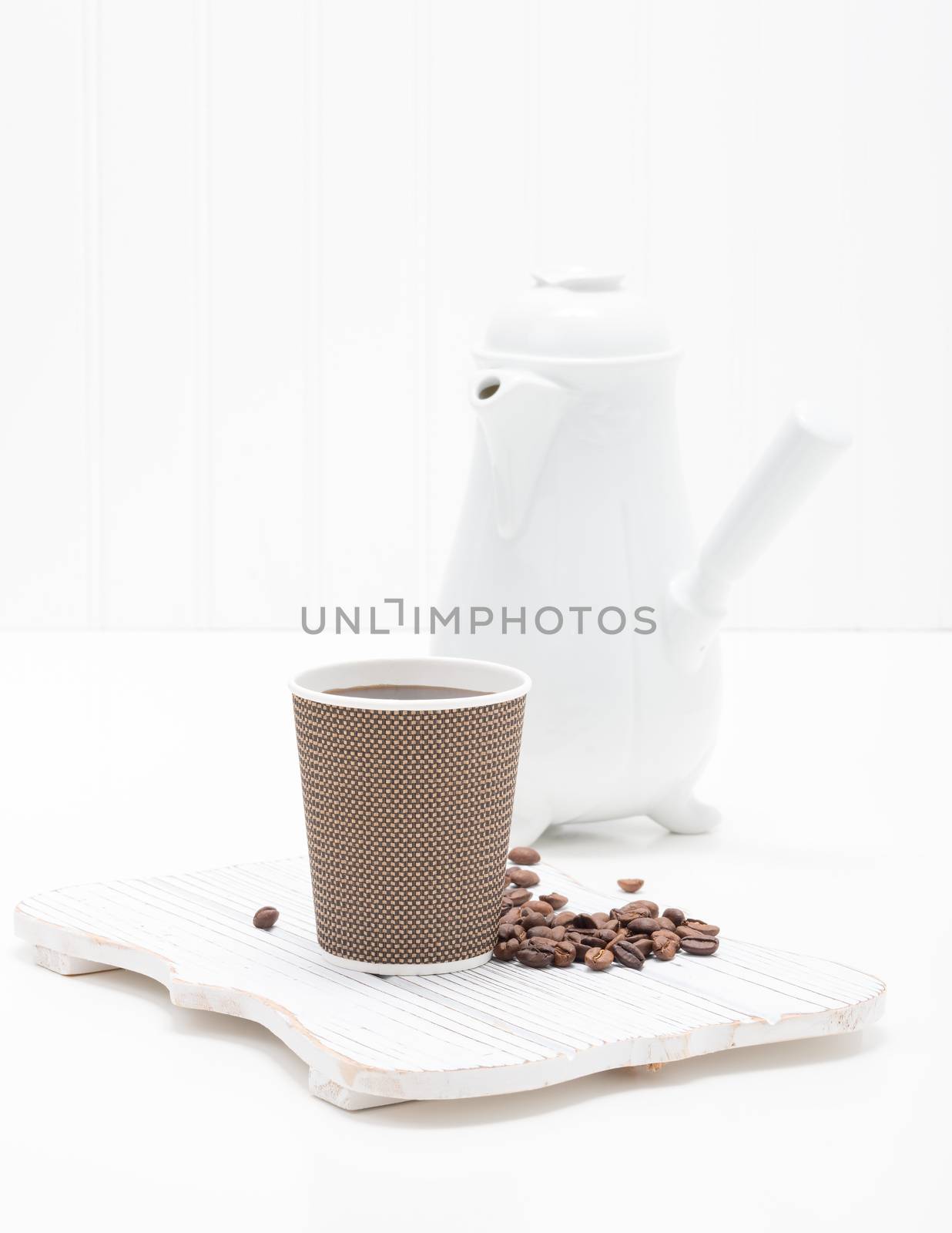 Fresh brewed coffee served in a disposable paper cup.