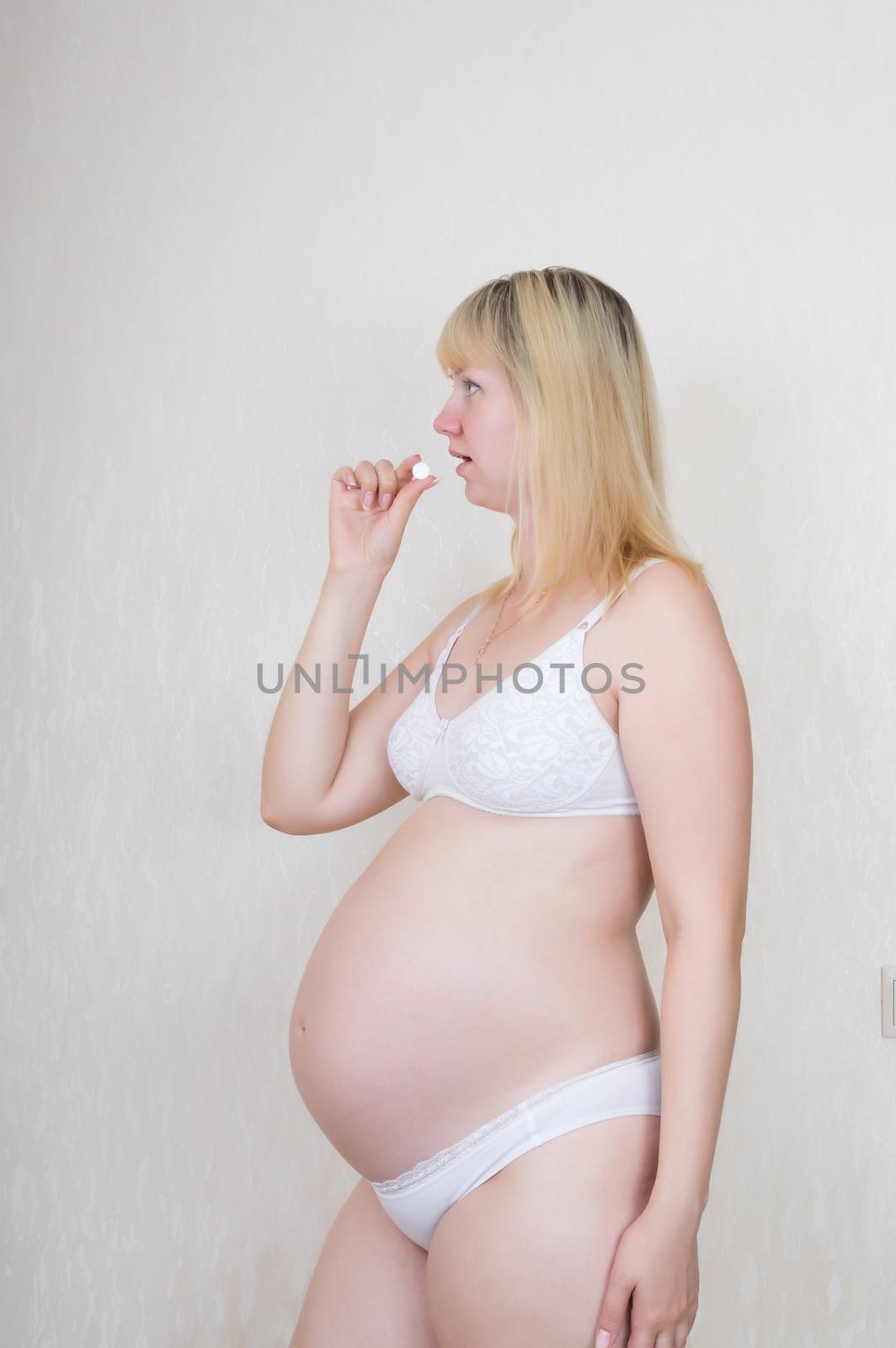 Pregnant woman brings to his mouth pills
