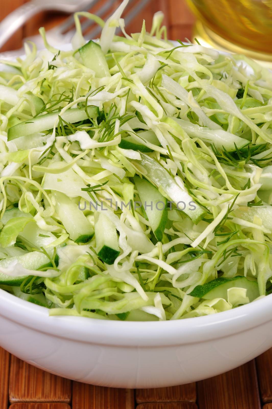 Salad of fresh coleslaw with cucumber and dill