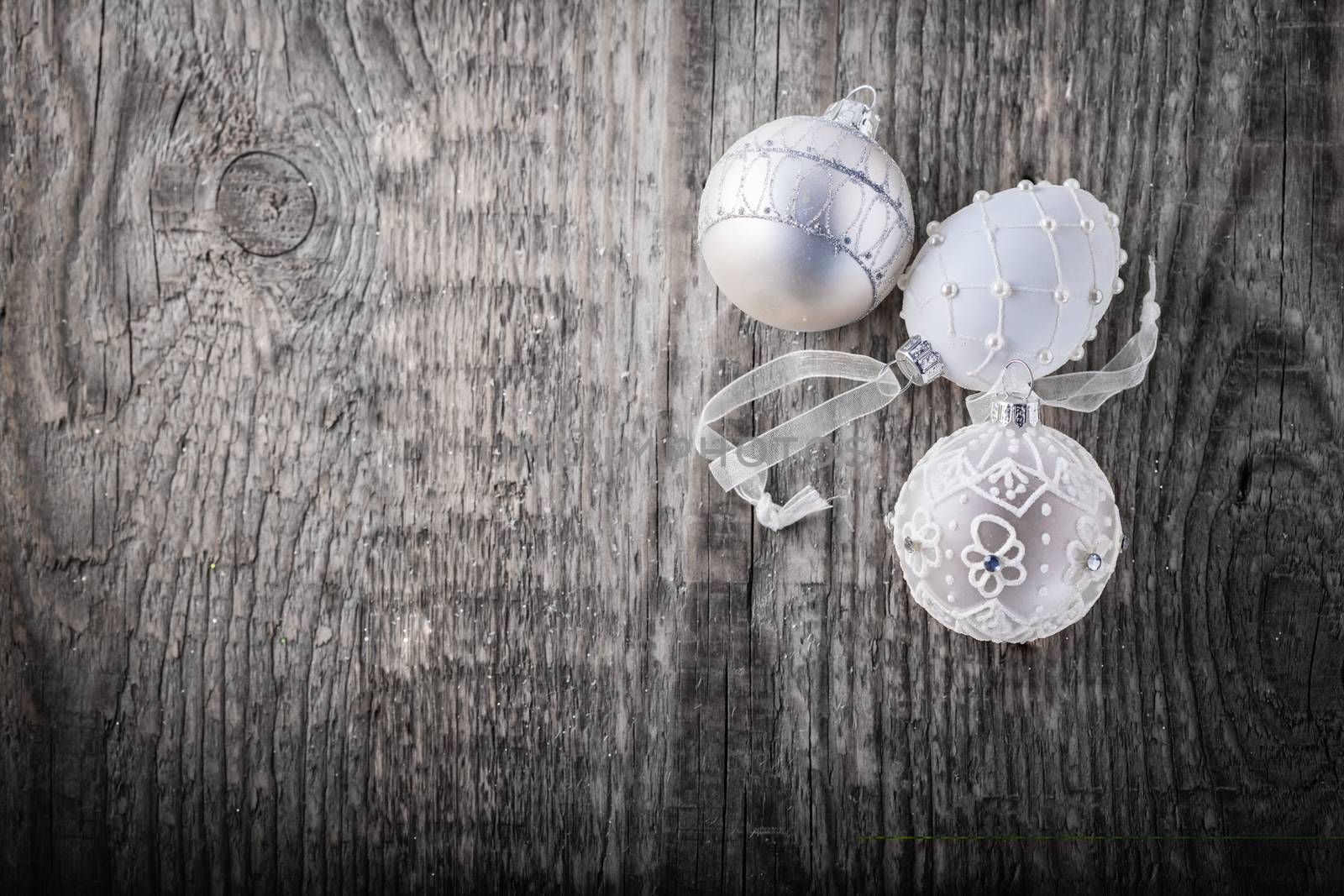 White christmas balls on a wooden background.  by supercat67