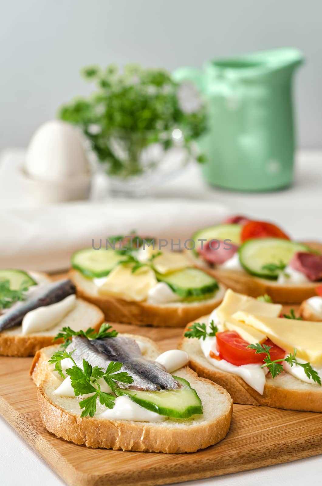 Variety of sandwiches on a cutting Board and ingredients. Selective focus.