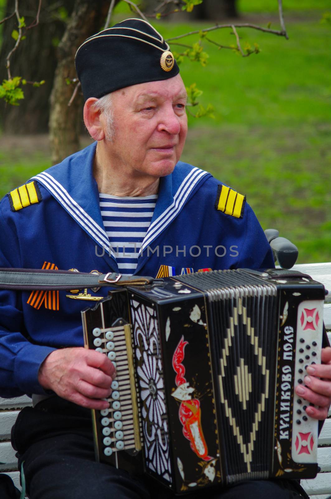 ST.PETERSBURG, RUSSIA - MAY 9, 2014: A very pleasent veteran plays accordion on the 69-th anniversary of the victory in the World War II on May 9, 2013, St.Petersburg, Russia