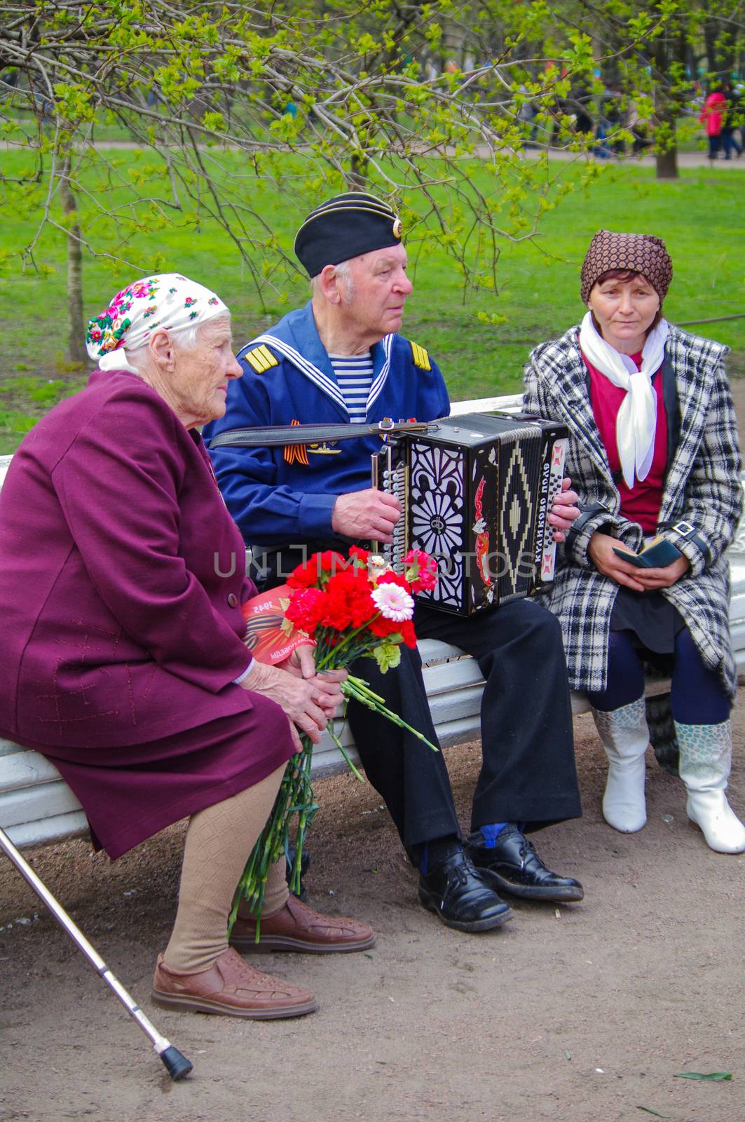 ST.PETERSBURG, RUSSIA - MAY 9, 2014: pleasent veteran plays accordion on the 69-th anniversary of the victory in the World War II , 2013 by evolutionnow