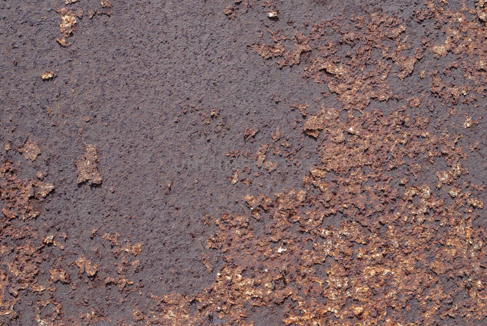 rusty iron surface covered with old chipped paint, which has long been influenced by different climatic conditions