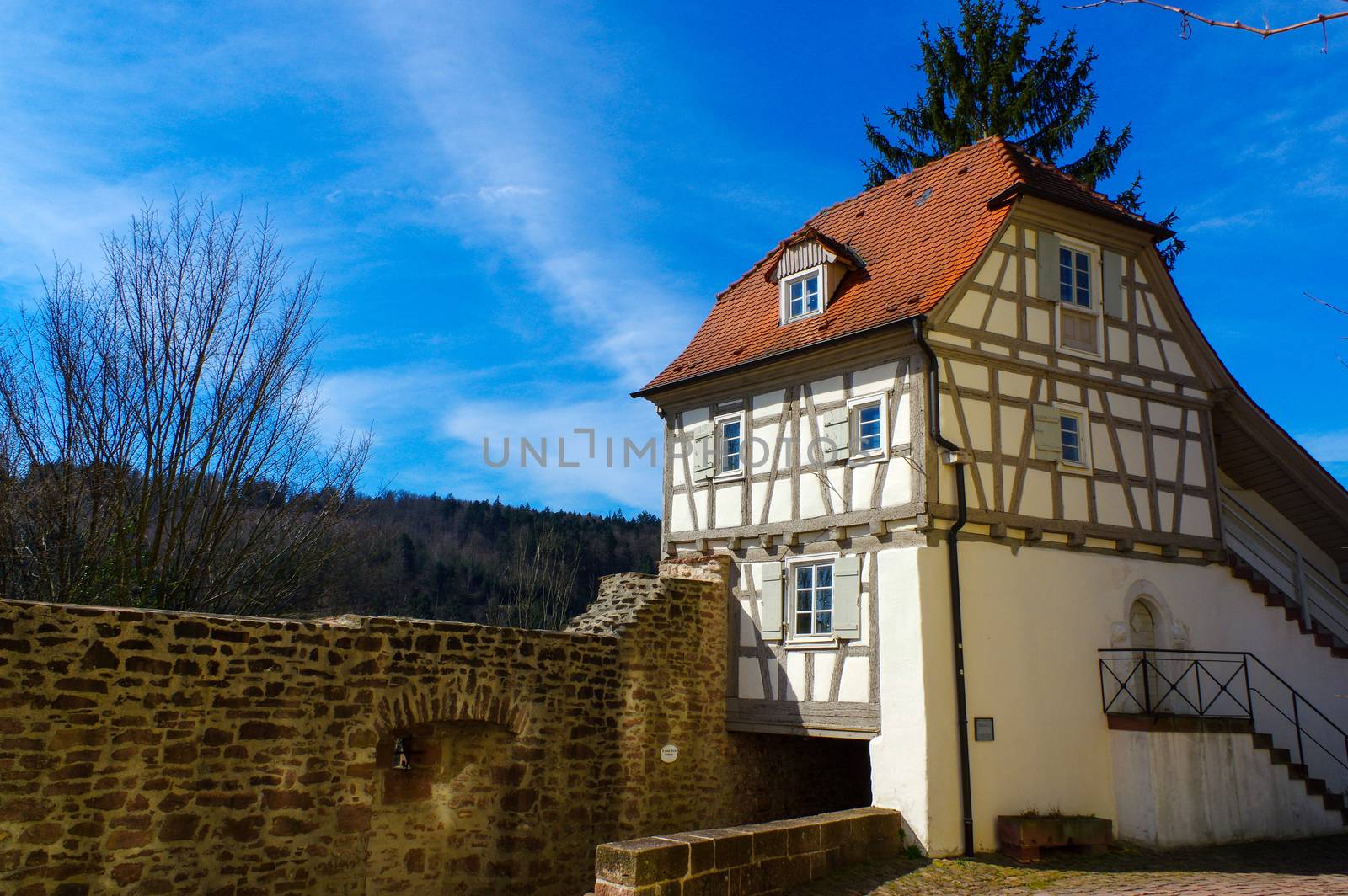 Residential tudor style house with blue sky in background by evolutionnow