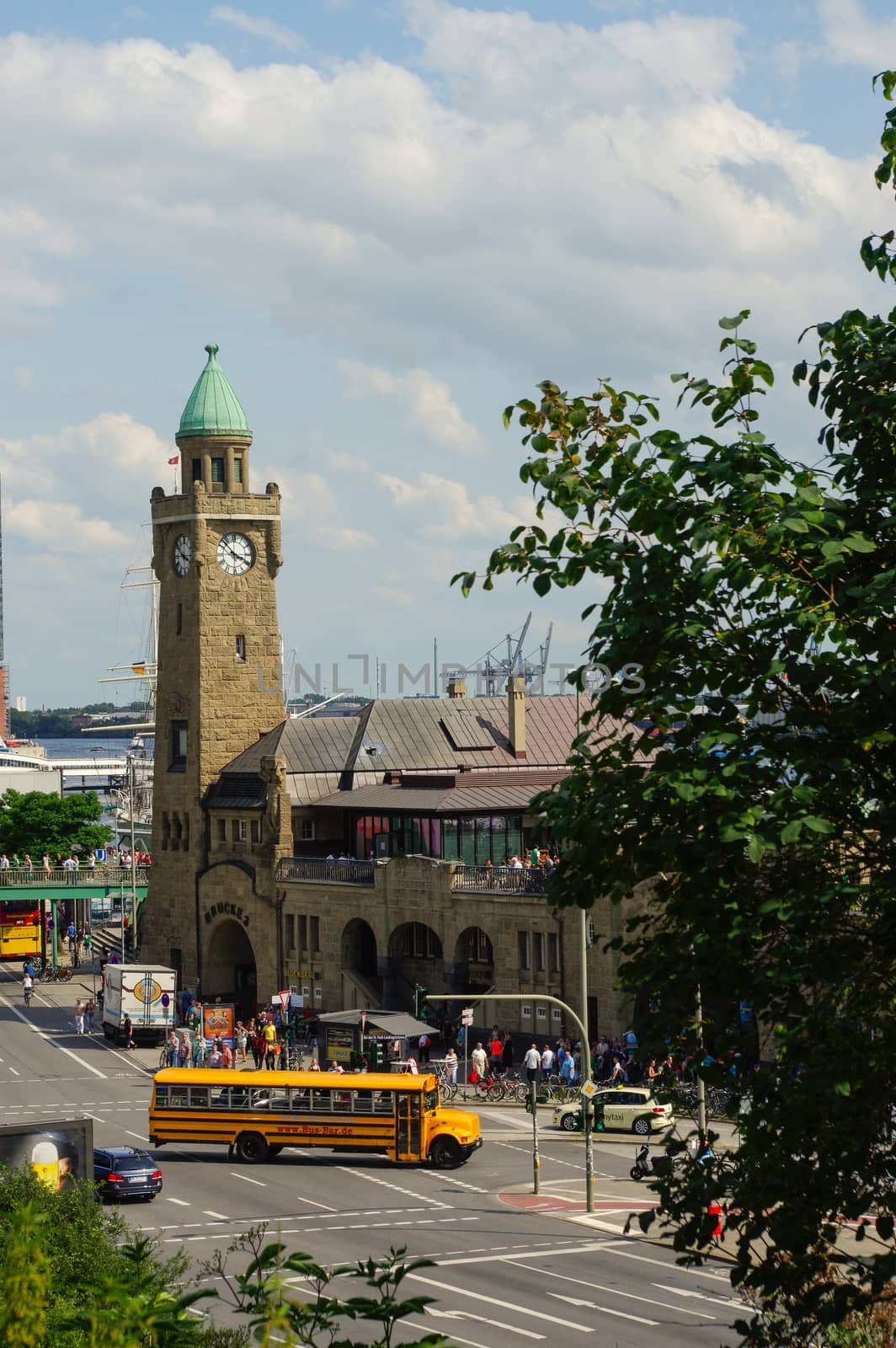 HAMBURG, GERMANY - JULY 18, 2016: Beautiful view of famous Landungsbruecken with commercial harbor and Elbe river, blue sky, clouds in summer, St. Pauli district by evolutionnow