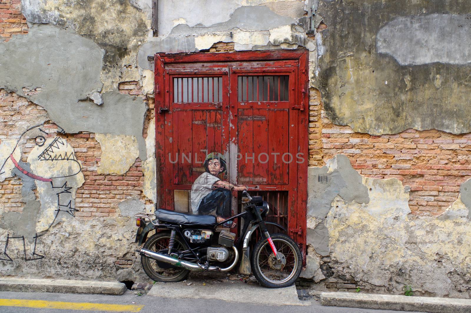PENANG, MALAYSIA - April 18, 2016: General view of a mural 'Boy on Bike' painted by Ernest Zacharevic. The is one the 9 murals paintings in early 2012. by evolutionnow
