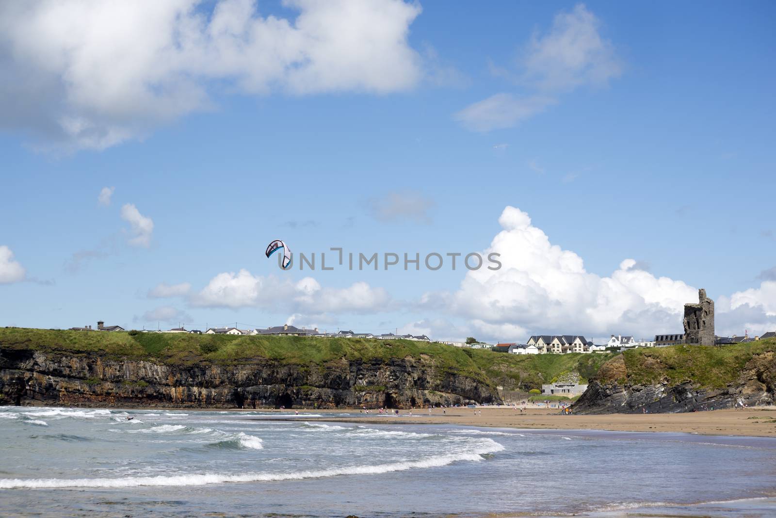 lone kite surfer surfing at ballybunion beach by morrbyte