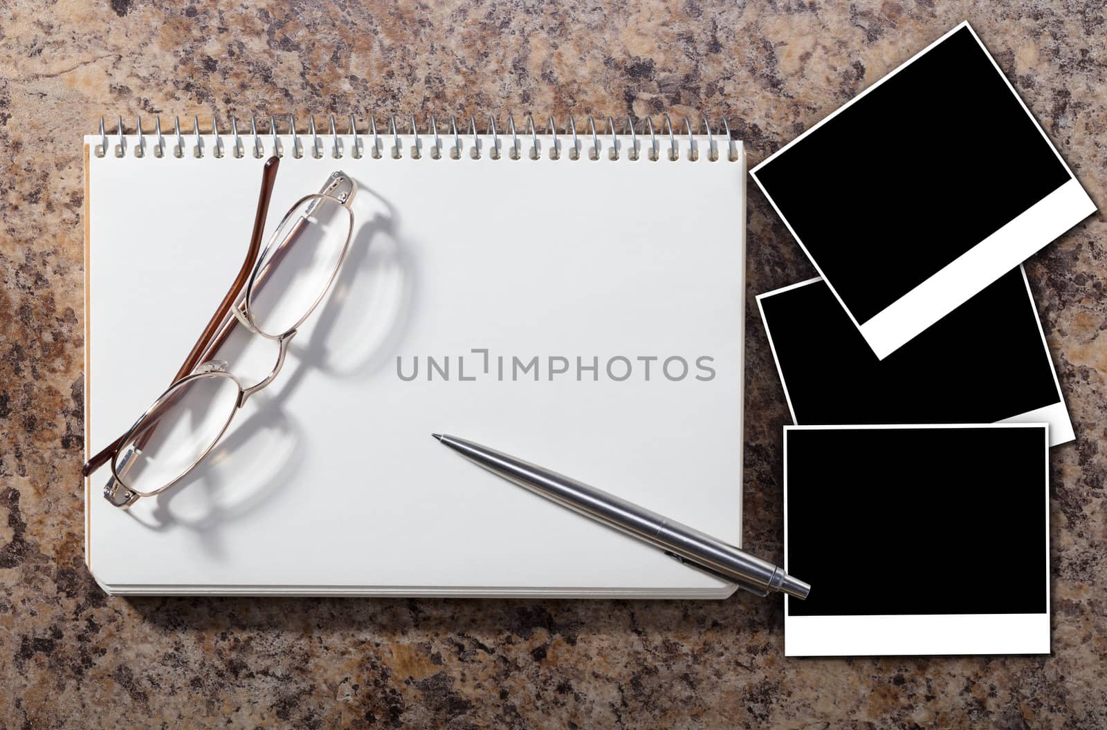 Notebook with empty photograph on a granite background