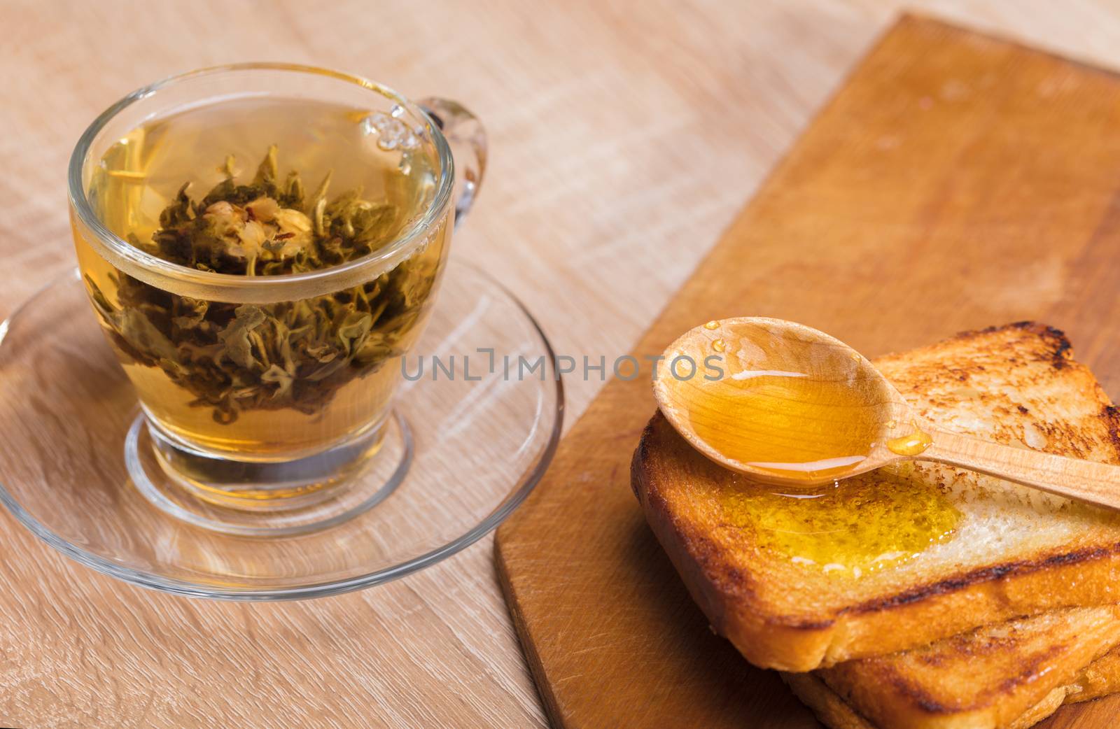 tea and toast with honey on wooden background