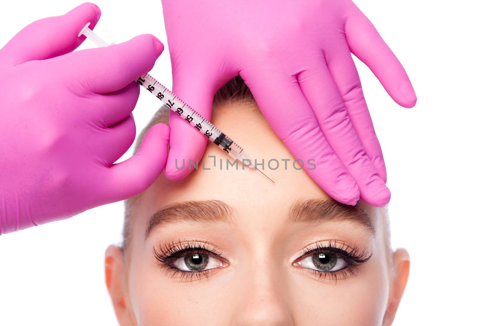 Beautiful face frown wrinkles filler collagen  injection on forehead Cosmetic skincare spa beauty treatment with pink gloves by eye, on white.