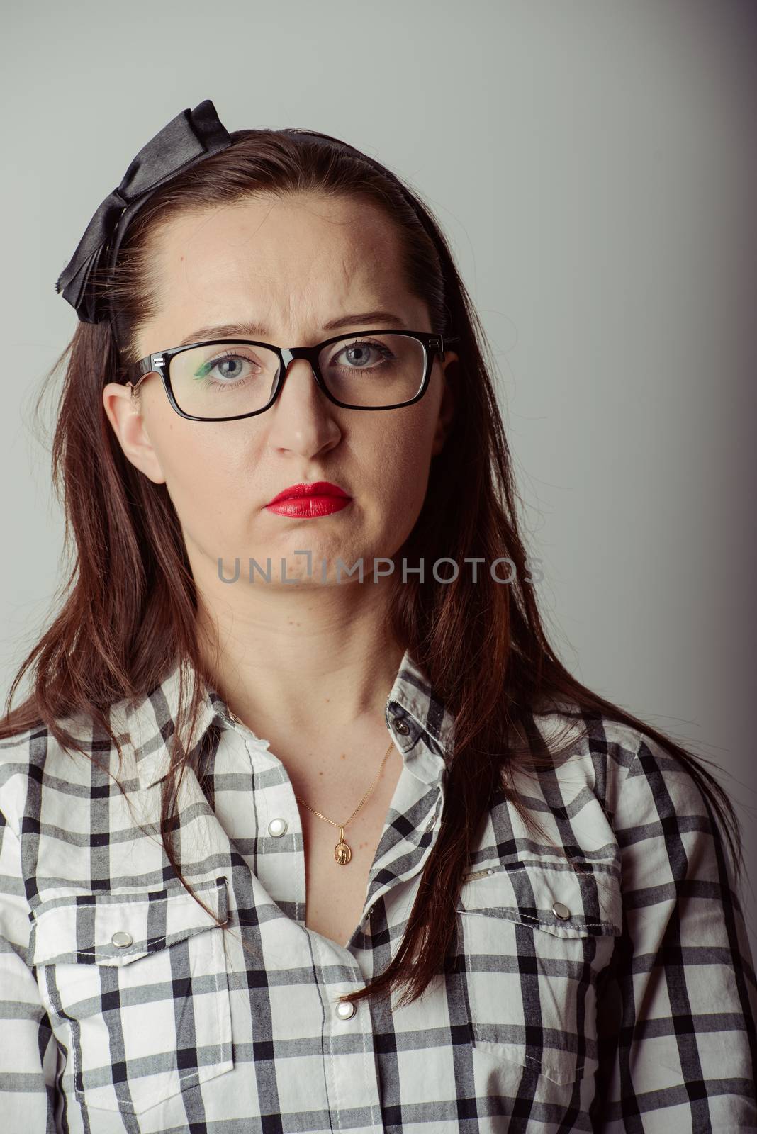 brunette young girl with disappointed expression on her face