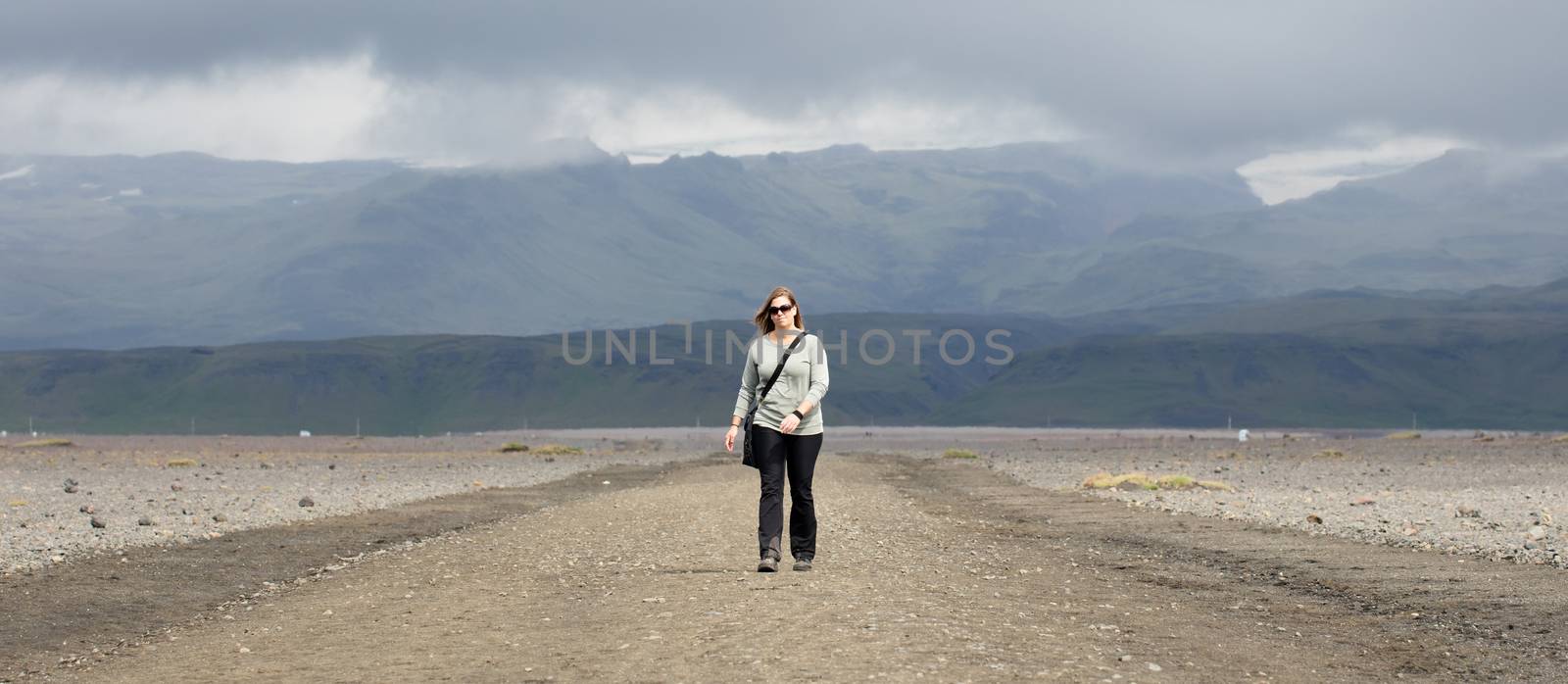 Woman hiker walking in mountain landscape by michaklootwijk