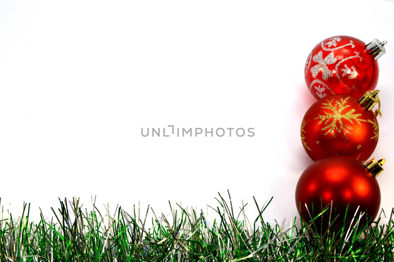 Three christmas balls and a green garland placing vertically  by Philou1000